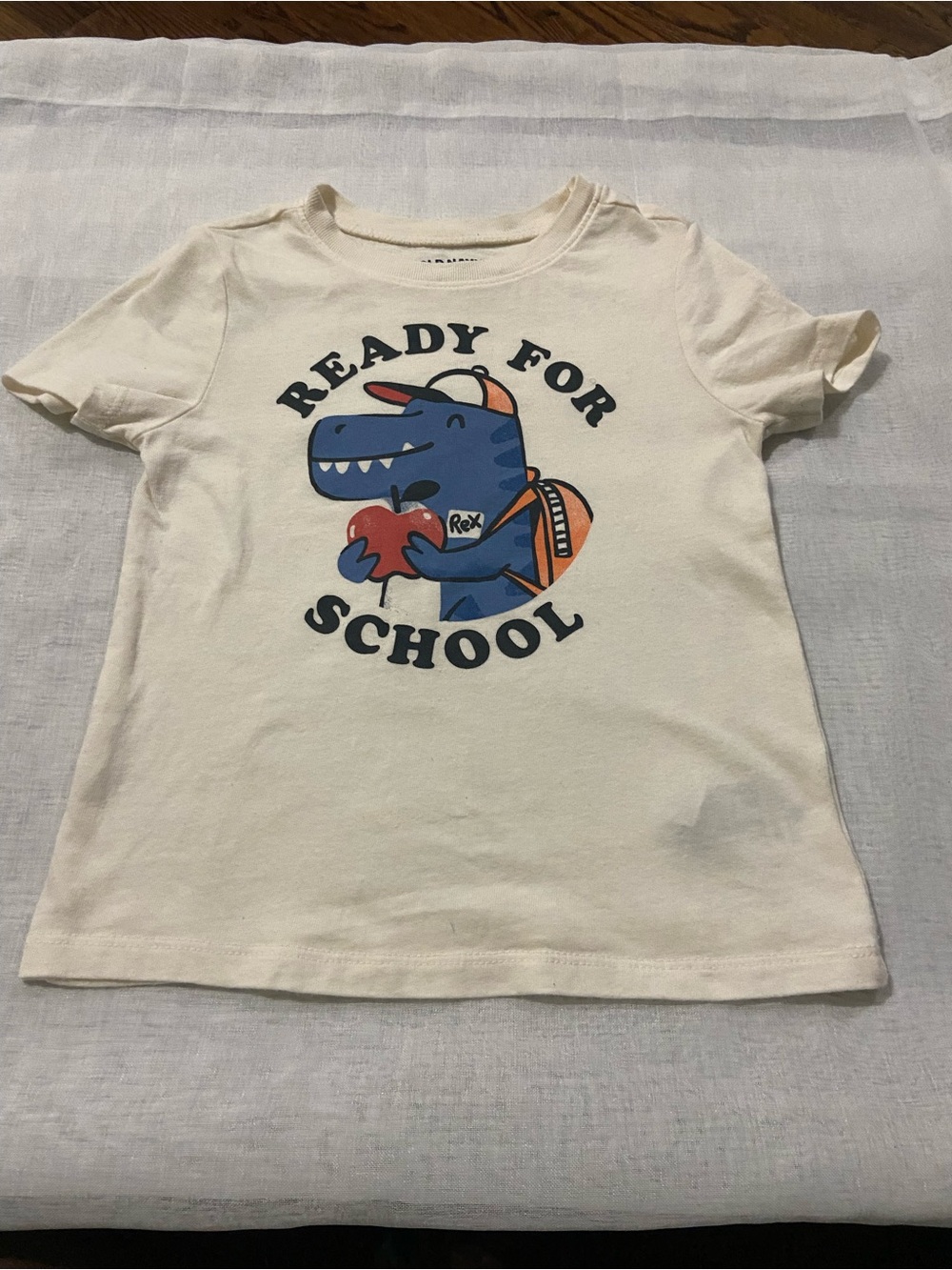 Old Navy Cream Tee with Blue Dinosaur and Orange Backpack
